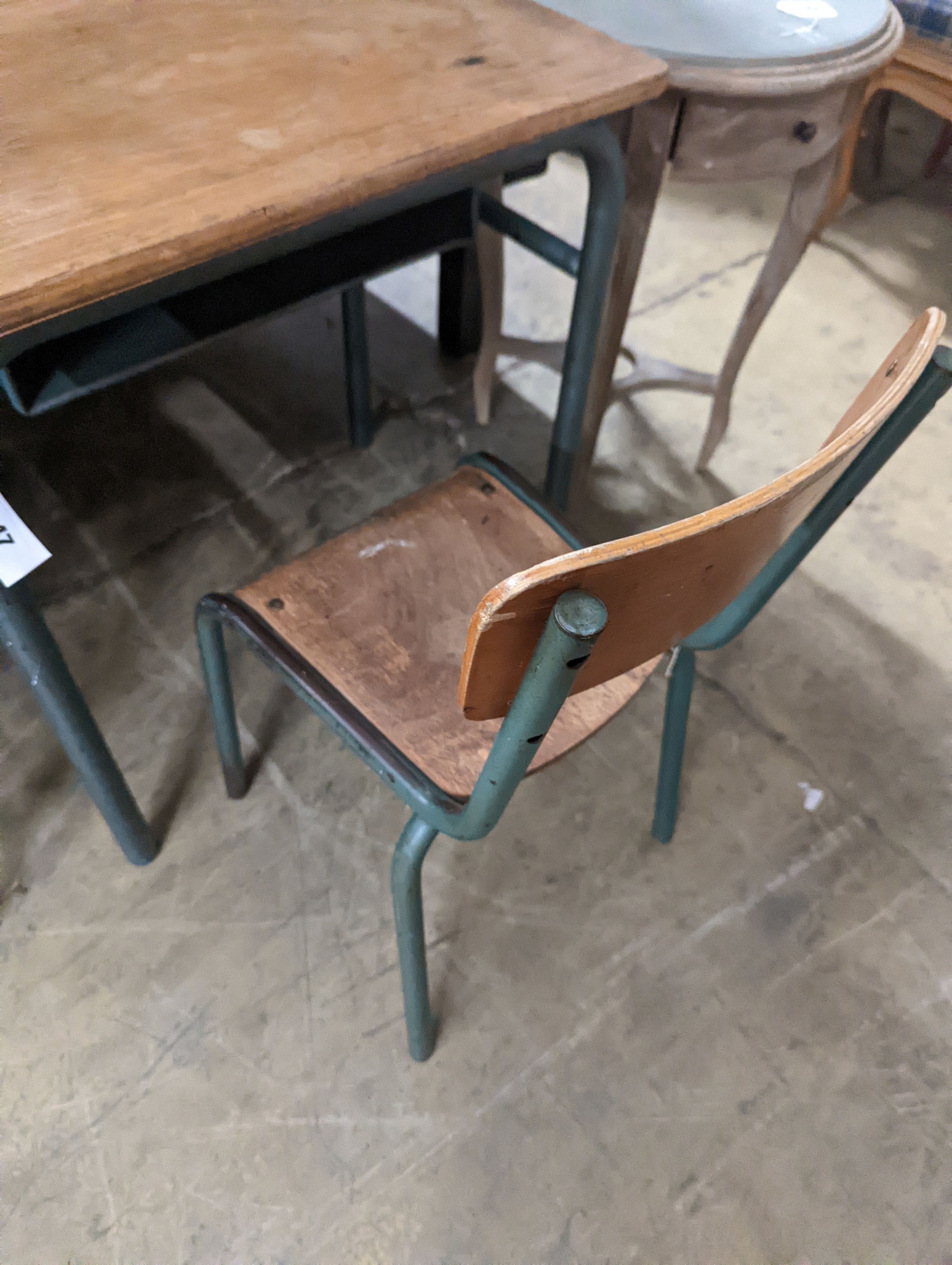 A child's oak and painted metal desk, length 59cm, depth 45cm, height 64cm and a chair